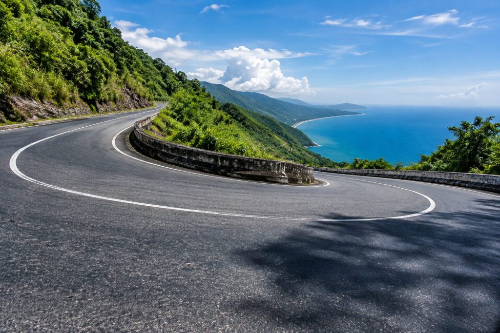 A sharp hairpin turn on the coastal mountain road of Hai Van Pass