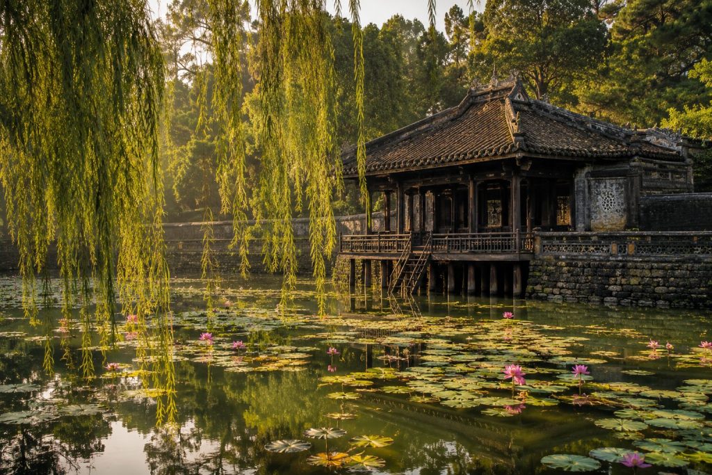 The poetic lotus lake and wooden pavilion at Tu Duc Tomb in Hue.