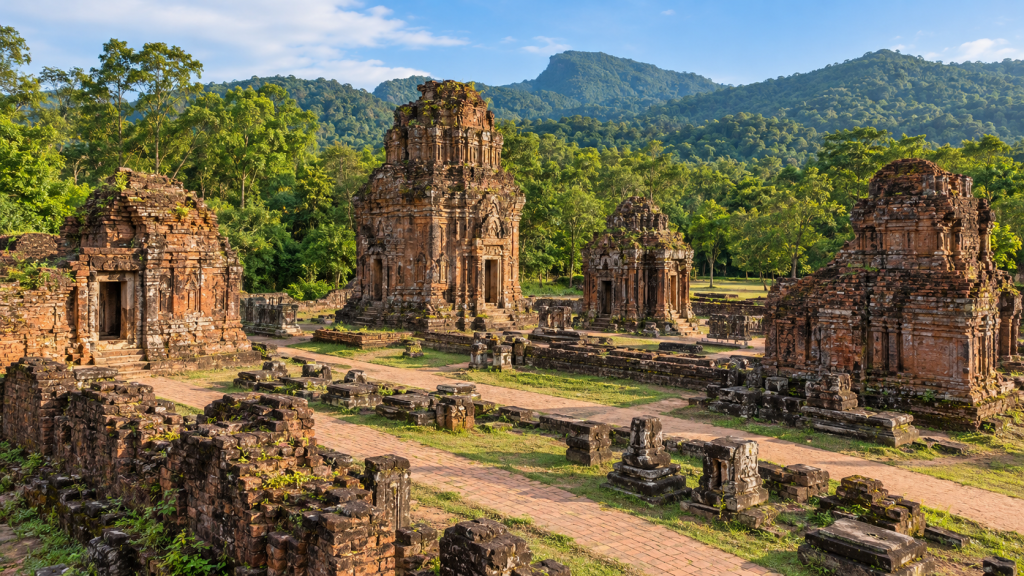 Wide view of several Cham temple structures around an archaeological courtyard